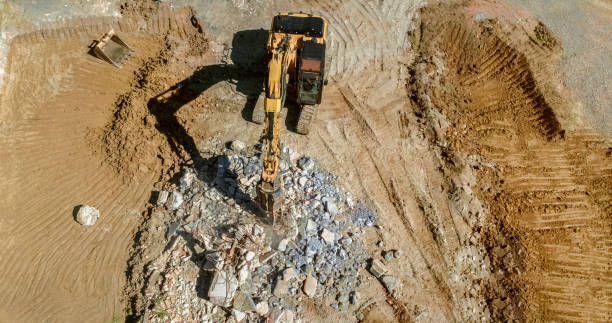 istock Excavator grapples clenching metal rods at construction site 1129582687