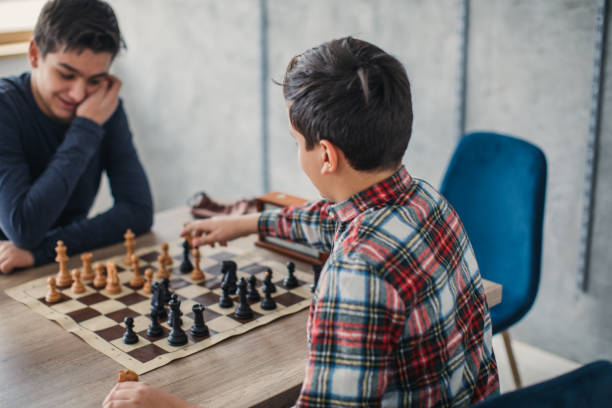 Smart boys playing chess in school of chess
