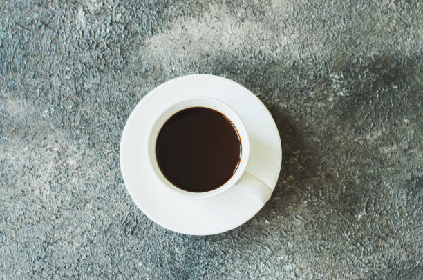 istock Single cup of coffee on a gray background. 1129587424