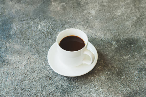 istock Single cup of coffee on a gray background. 1129587453