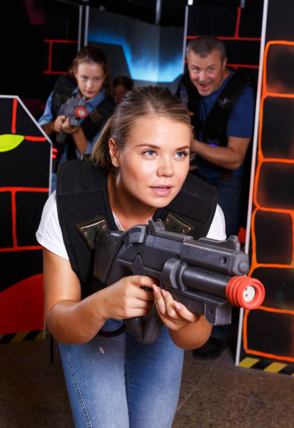 istock Woman playing lasertag with family 1129593285