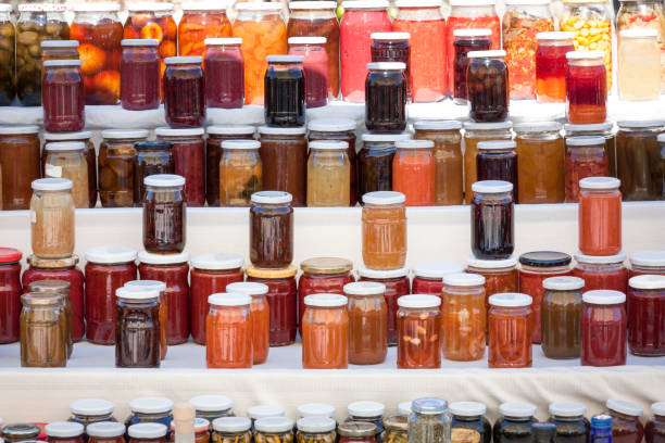 A jar of homemade strawberry jam on white background