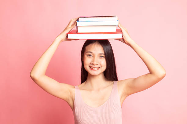 istock Young Asian woman studying  with may books. 1129594103