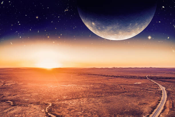 istock Unreal alien panoramic landscape - planet rising over desert and road at sunrise. Elements of this image are furnished by NASA 1129595496