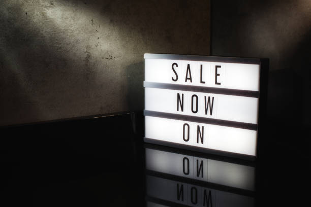 istock Sale now on message on a light box with a dark cinematic feel 1129596880