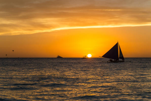 istock Small sailing boats at the sunset. Boracay, Philippines 1129598126