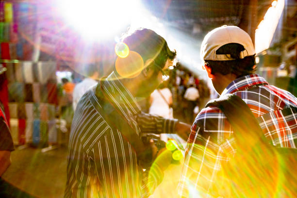 Travel, Tourism, Middle East - Young Travelers Visiting Dubai's Traditional Souq and Referring to a local tourist map to visit their next tourist attraction.