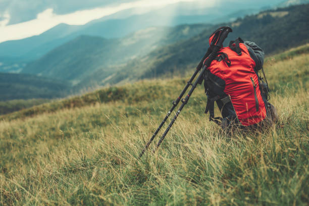 istock Touristic backpack lying on the grass of the mountain hills 1129600800