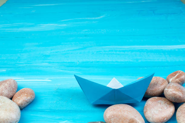 istock Sand, seashells, stones, ship on a blue background. Concept of rest. Top view. 1129600886