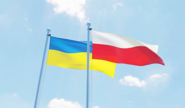 istock Poland and Ukraine, two flags waving against blue sky 1129603515