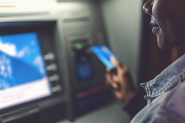 istock Woman at the ATM device 1129605921