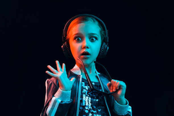 istock Young girl with headphones enjoying music 1129606607