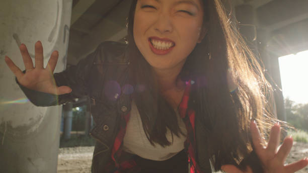 Angry young woman screaming to a camera