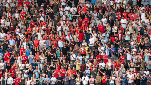 istock Group of spectators cheering in stadium 1129607806