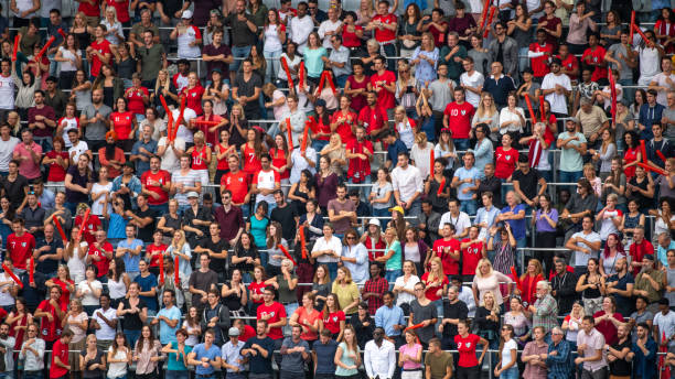 istock Group of spectators cheering in stadium 1129607807