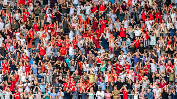 istock Group of spectators cheering in stadium 1129607810