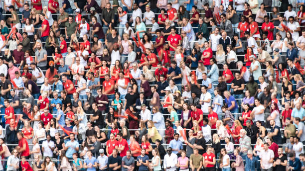 istock Group of spectators cheering in stadium 1129607811