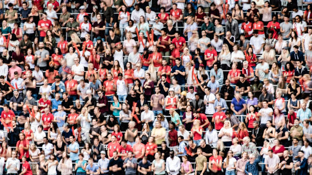 istock Group of spectators cheering in stadium 1129607813