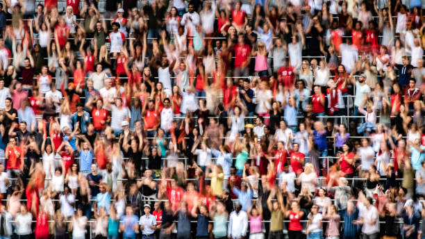 istock Group of spectators cheering in stadium 1129607814