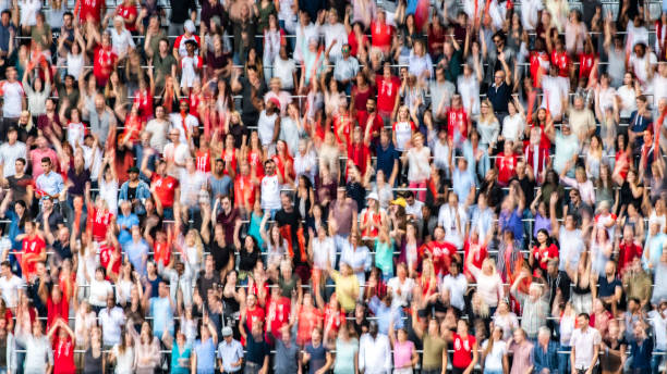 istock Group of spectators cheering in stadium 1129607817