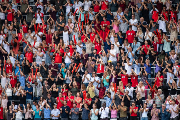 istock Group of spectators cheering in stadium 1129607824