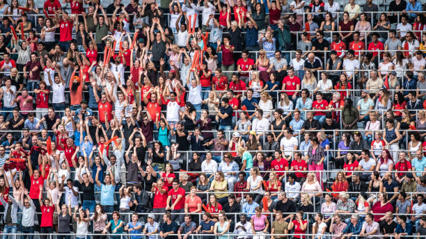 istock Group of spectators cheering in stadium 1129607826