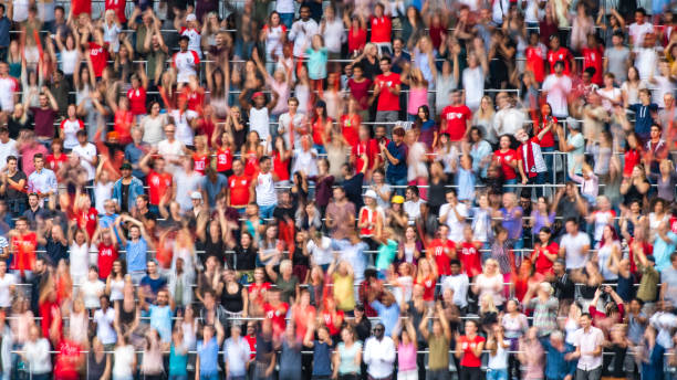 istock Group of spectators cheering in stadium 1129607828
