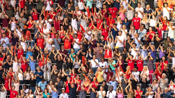 istock Group of spectators cheering in stadium 1129607829