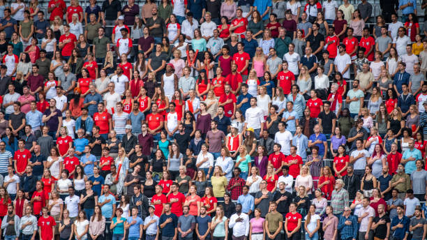 istock Group of spectators singing national anthem in stadium 1129607831