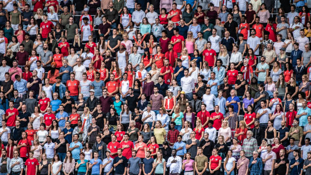 istock Group of spectators singing national anthem in stadium 1129607832