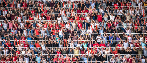 istock Group of spectators cheering in stadium 1129607838