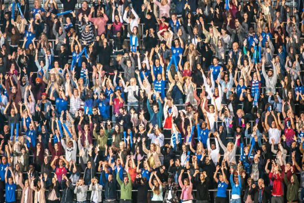 istock Group of spectators cheering in stadium 1129607839