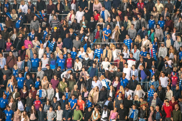 istock Group of spectators cheering in stadium 1129607845