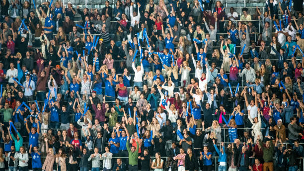 istock Group of spectators cheering in stadium 1129607850