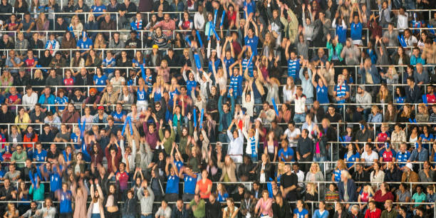 istock Group of spectators cheering in stadium 1129607852