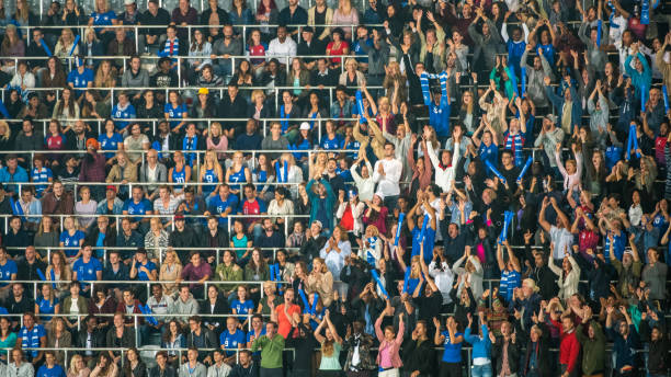 istock Group of spectators cheering in stadium 1129607853