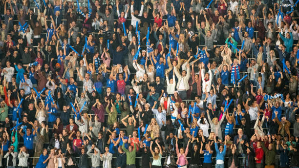 istock Group of spectators cheering in stadium 1129607855