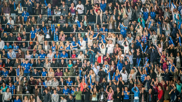 istock Group of spectators cheering in stadium 1129607856