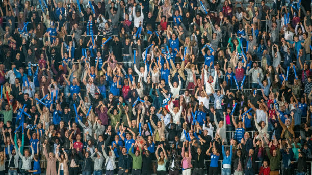 istock Group of spectators cheering in stadium 1129607857