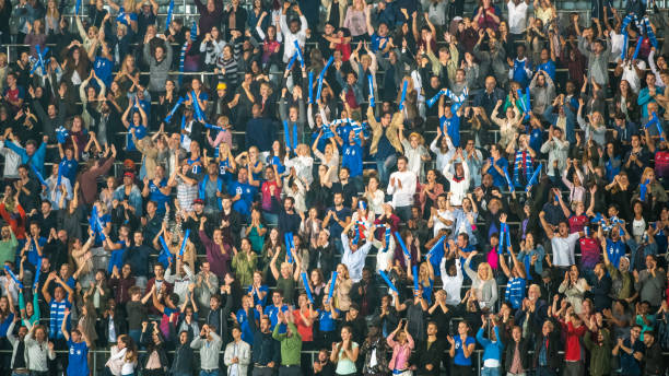 istock Group of spectators cheering in stadium 1129607860