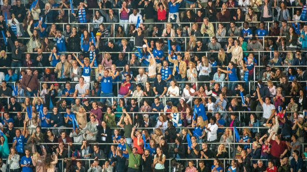 istock Group of spectators cheering in stadium 1129607868