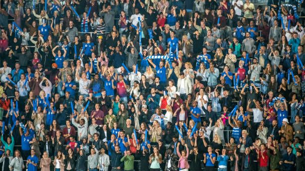 istock Group of spectators cheering in stadium 1129607869
