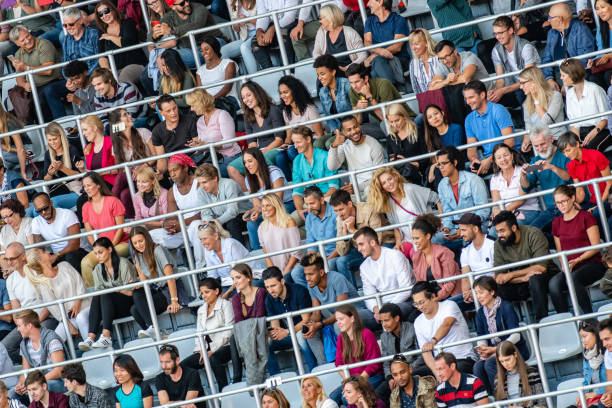 istock Group of spectators cheering in stadium 1129607871