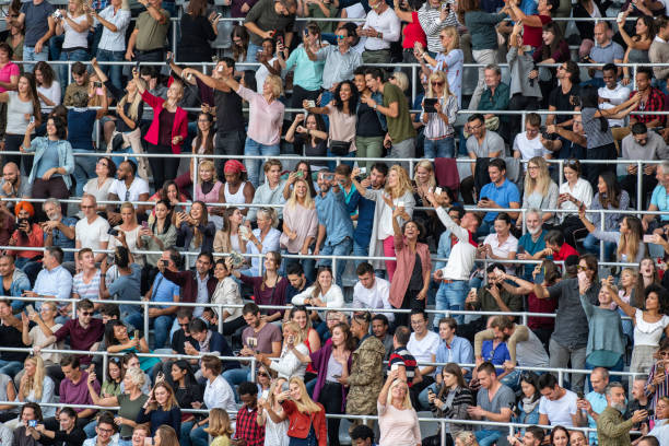 istock Group of spectators cheering in stadium 1129607873