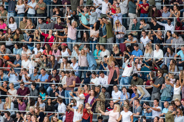 istock Group of spectators cheering in stadium 1129607874