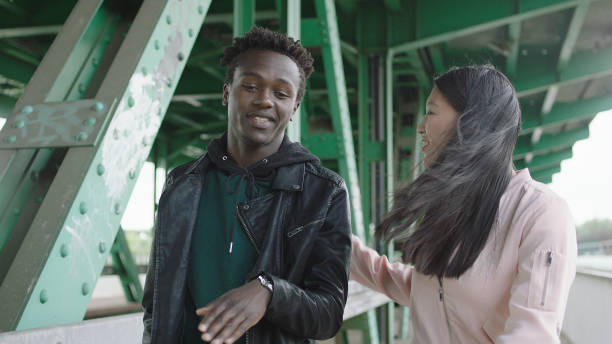 istock Young multi ethnic couple dating under old bridge 1129608979