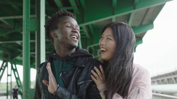 istock Young multi ethnic couple dating under old bridge 1129609002