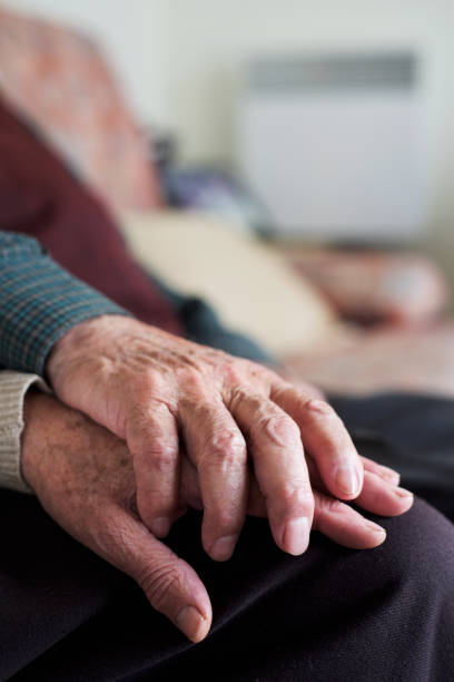 istock old man and old woman holding hands 1129609198
