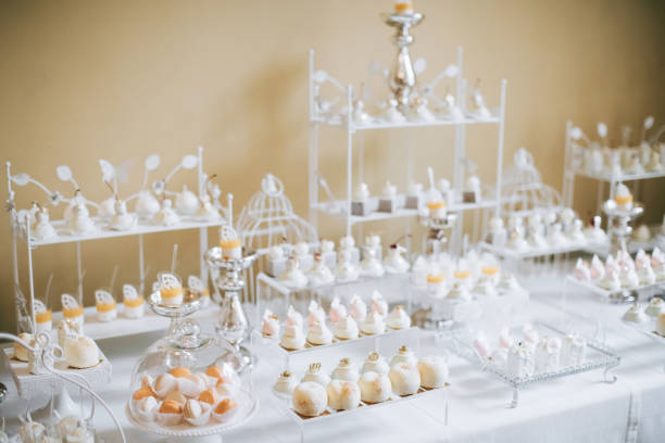 istock Wedding reception dessert table with delicious decorated white cupcakes 1129610495