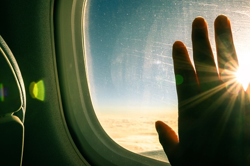 Person is looking outside of window while his traveling